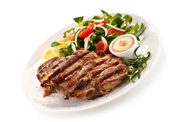 Grilled steak with vegetables on white background