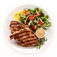 Grilled steak with vegetables on white background