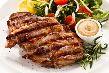 Grilled steak with vegetables on white background