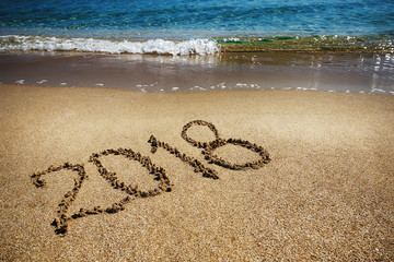 The inscription on the sand of the sea in 2018, a concept - the beginning of the new year