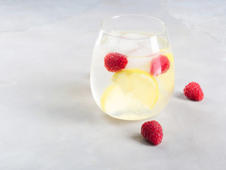 Cocktail with raspberries and lemon slices or infused detox water