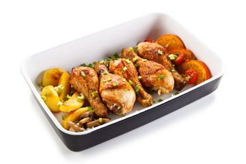 Roast chicken drumsticks and vegetables