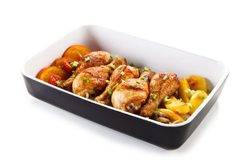 Roast chicken drumsticks and vegetables