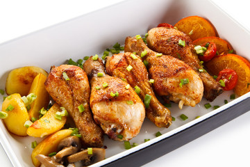 Roast chicken drumsticks and vegetables