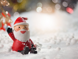 Cute happy Santa Claus dolls and Christmas props decorations on christmas snow field background with copy space.Merry Christmas and happy new year concept.