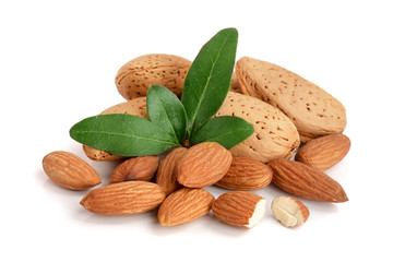 Group of almond nuts with leaves isolated on white background