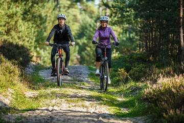Healthy lifestyle - people riding bicycles in city park