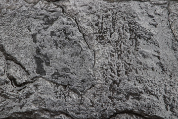 Black wet stone texture.
