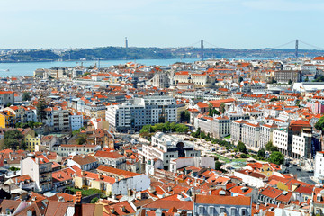 Obraz premium Alfama downtown and the 25 April Bridge in Lisbon, Portugal.