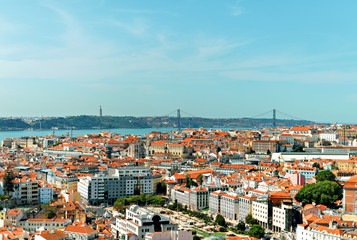 Naklejka na ściany i meble Alfama downtown and the 25 April Bridge in Lisbon, Portugal.