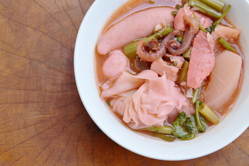 Chinese dumpling stuff minced pork with fish ball and pickled squid in red soup