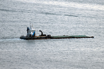 Obraz premium The barge floats along the river.