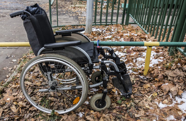 Wheelchair among fallen leaves