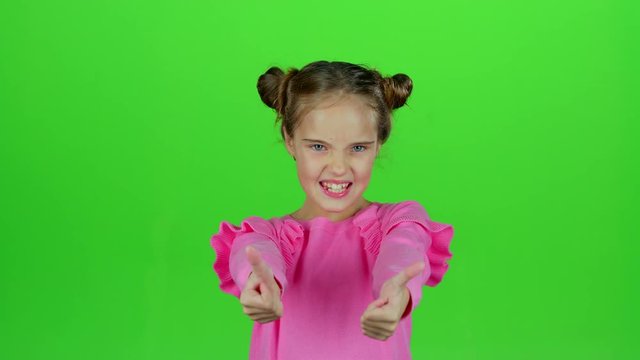 Child shows thumbs up. Green screen. Slow motion