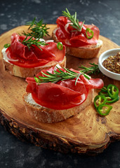 salted bresaola beef, Italian bruschetta with soft chees, onions, whole grain mustard, chillies and fresh rosmary.