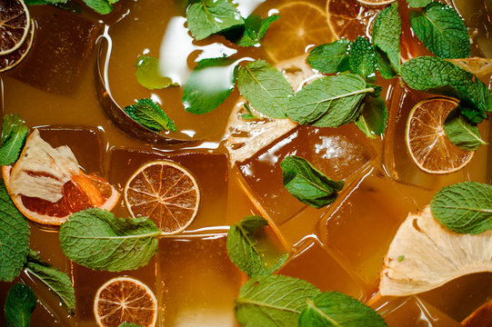 Top view of fresh orange lemonade drink with ice and mint
