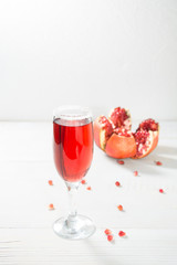 Wineglass with red pomegranate juice with copy space