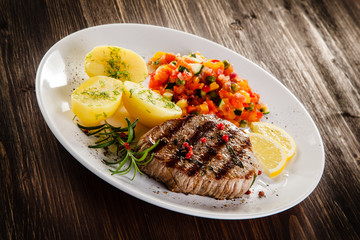 Grilled steak, boiled potatoes and vegetable salad
