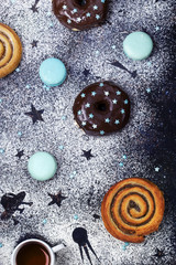 donuts with chocolate and macaroons on a dark background