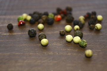 Different kinds of pepper are scattered on the table.