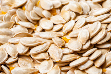 raw pumpkin seeds as background