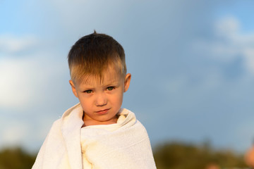 boy wrapped in a white towel