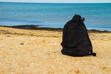 Travel backpack on summer sandy sea beach