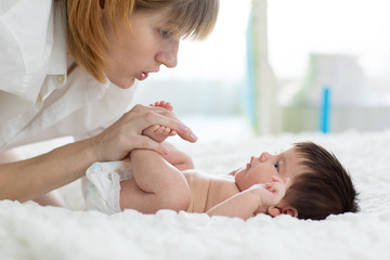 Mother gently massaging her baby's feet