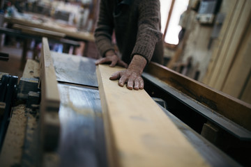 Close up shot of old master carpenter working in his woodwork or workshop