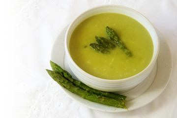 soup from green asparagus in a bowl, background fades to white, copy space, selected focus, narrow...