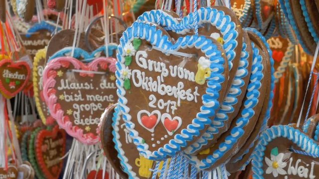 MUNICH, GERMANY, SEPTEMBER 16, 2017: Traditional Colorful Gingerbread Heart Shaped at the Oktoberfest Festival, Bavaria, Germany. Showcase Tent shop with festive pastries. World Beer Festival.