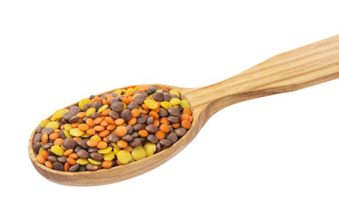 Fototapeta na wymiar Lentils mix in wooden spoon isolated on white background. Mixed red, yellow and brown lentils.