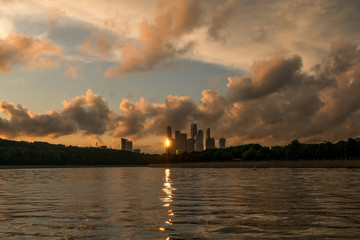 A city on the banks of the river at sunset