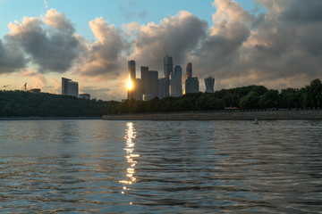 A city on the banks of the river at sunset