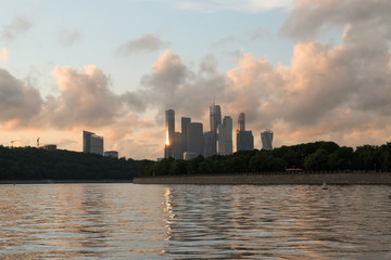 A city on the banks of the river at sunset