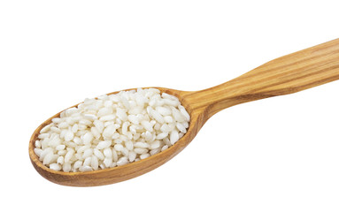 Risotto rice in wooden spoon isolated on white background