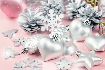 Silver Christmas ornaments close up on a pastel background
