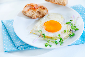 Healthy breakfast. Fried heart shaped egg closeup