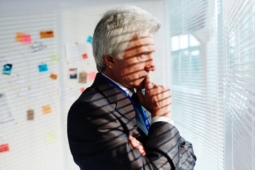 Thoughtful man concentrating on developing his ideas of crime proof