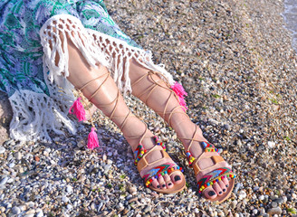 leather greek sandals advertisement on the beach - bohemian style clothing