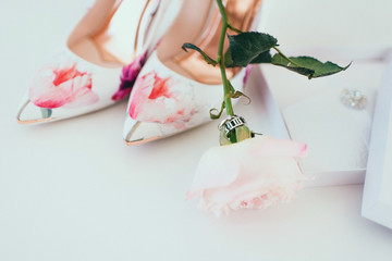 Beautiful light shoes fiancees cost near a varicoloured bouquet and accessories on a white background