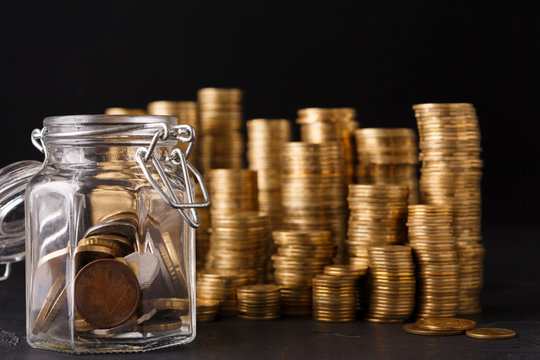 Coins in glass jar for money saving, copy space