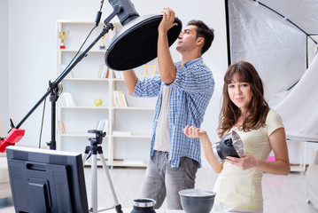 Young photographer working in photo studio