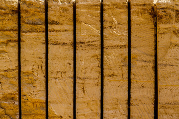 Yellow building blocks from sandstone in a quarry for excavation of rock