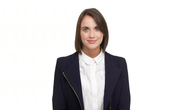 horizontal portrait of beautiful brunette lady 20s in business-like style being satisfied with work smiling nodding meaning agreement over white background. Concept of emotions