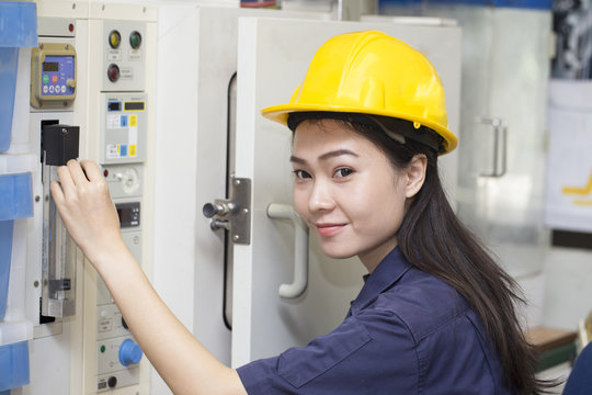 young asian woman engineer set up and testing machine in the laboratory factory, engineering and industrial concept