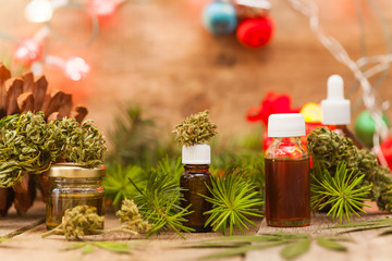 Green leaves of medicinal cannabis with extract oil on a wooden table