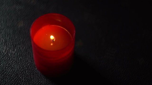 The one red candle closeup image in The Dark
