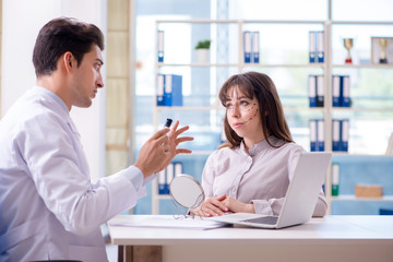 Plastic surgeon preparing for operation on woman face