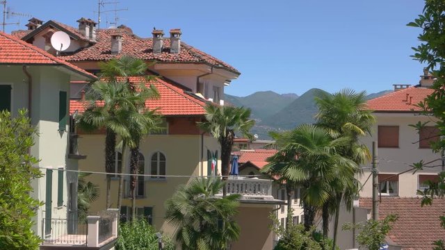 Blue sky, Stresa town. Palm trees and buildings. Warmest places in Europe.